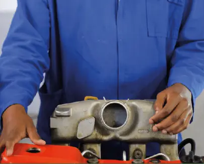 Trainee inspecting a diesel engine component